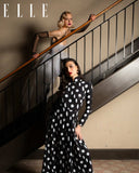 Two women in elegant dresses standing on a staircase with 'ELLE' branding. Mara Megelea