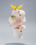 Jewelry display with rings and a banana on a gray background. Mara Megelea Prestige Magazine